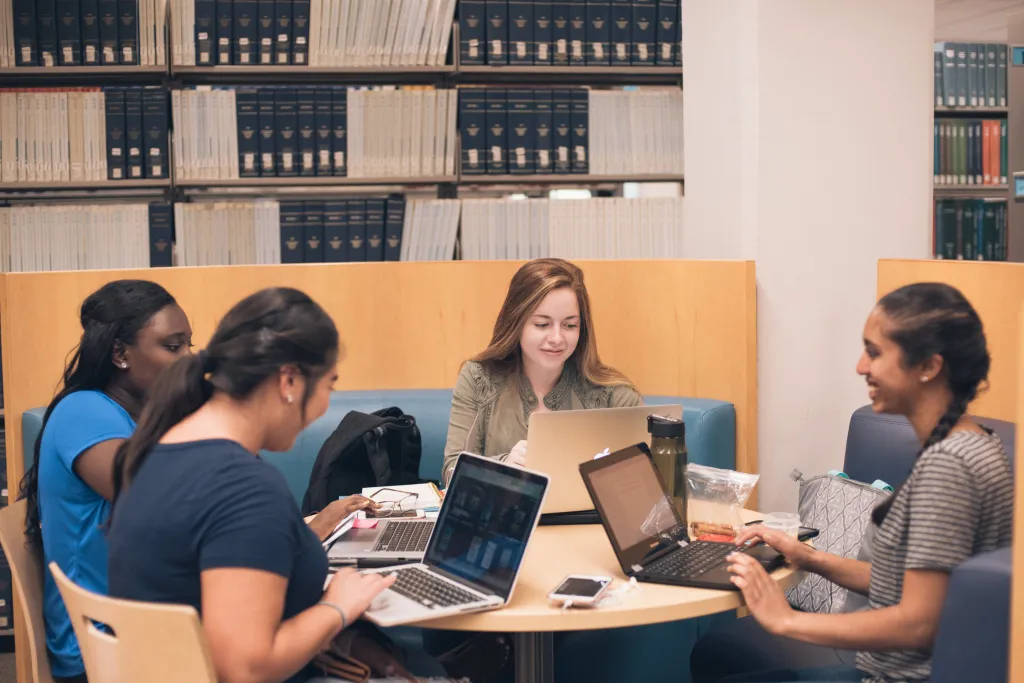 Students working on their computers in the library